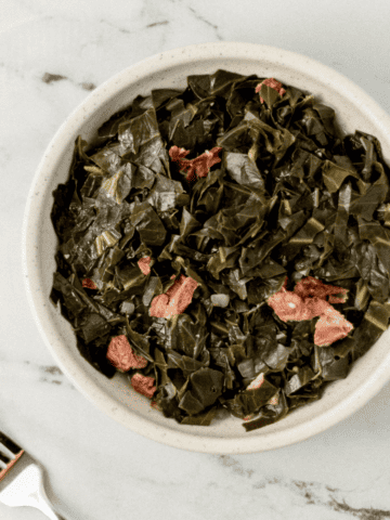 overhead view of greens in a bowl beside a fork