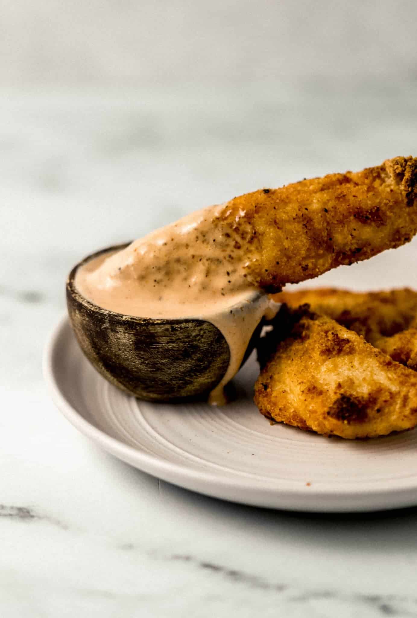 place of chicken finger with a small wooden bowl of sauce in it.