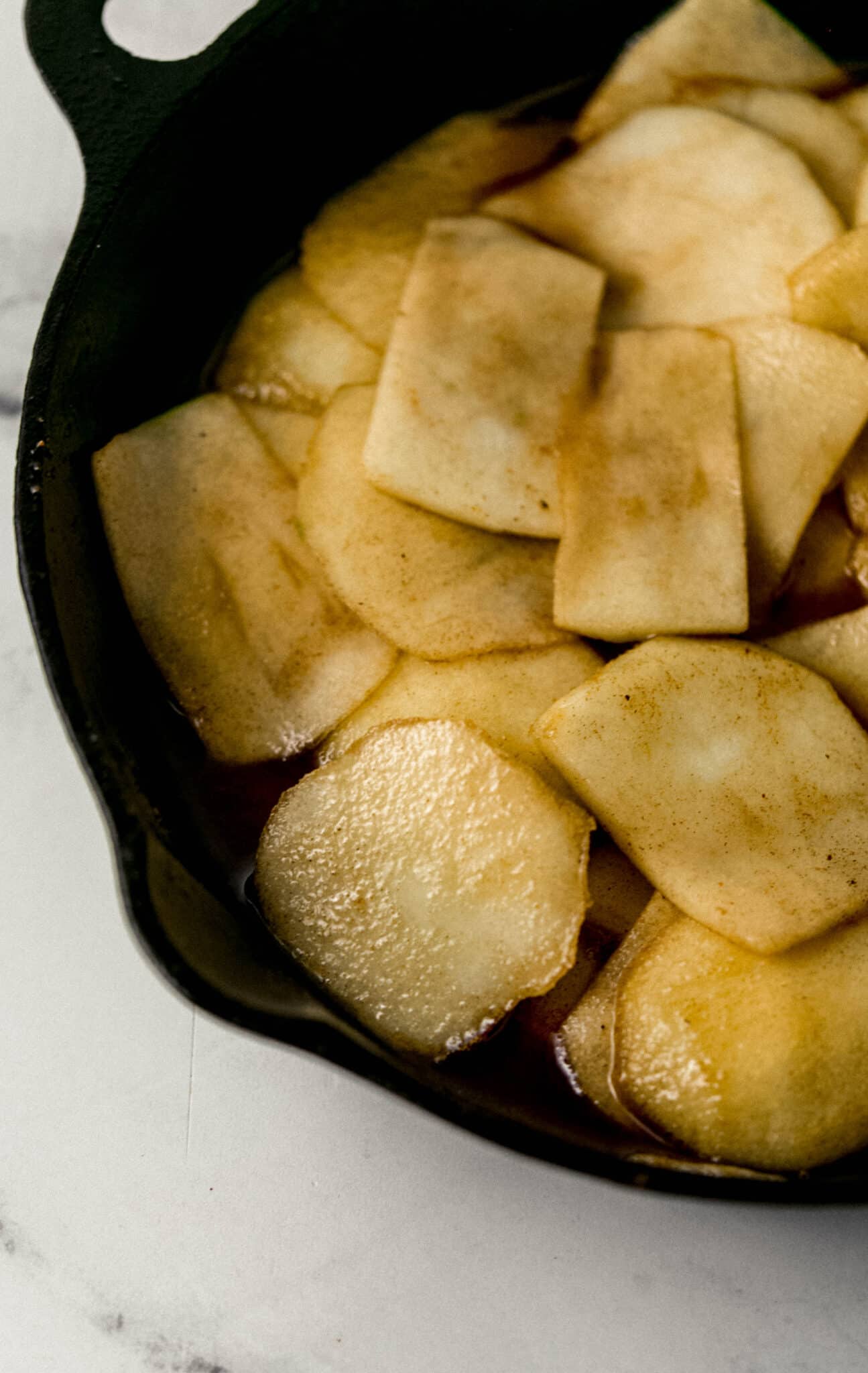 close up side view of finished apples in skillet 