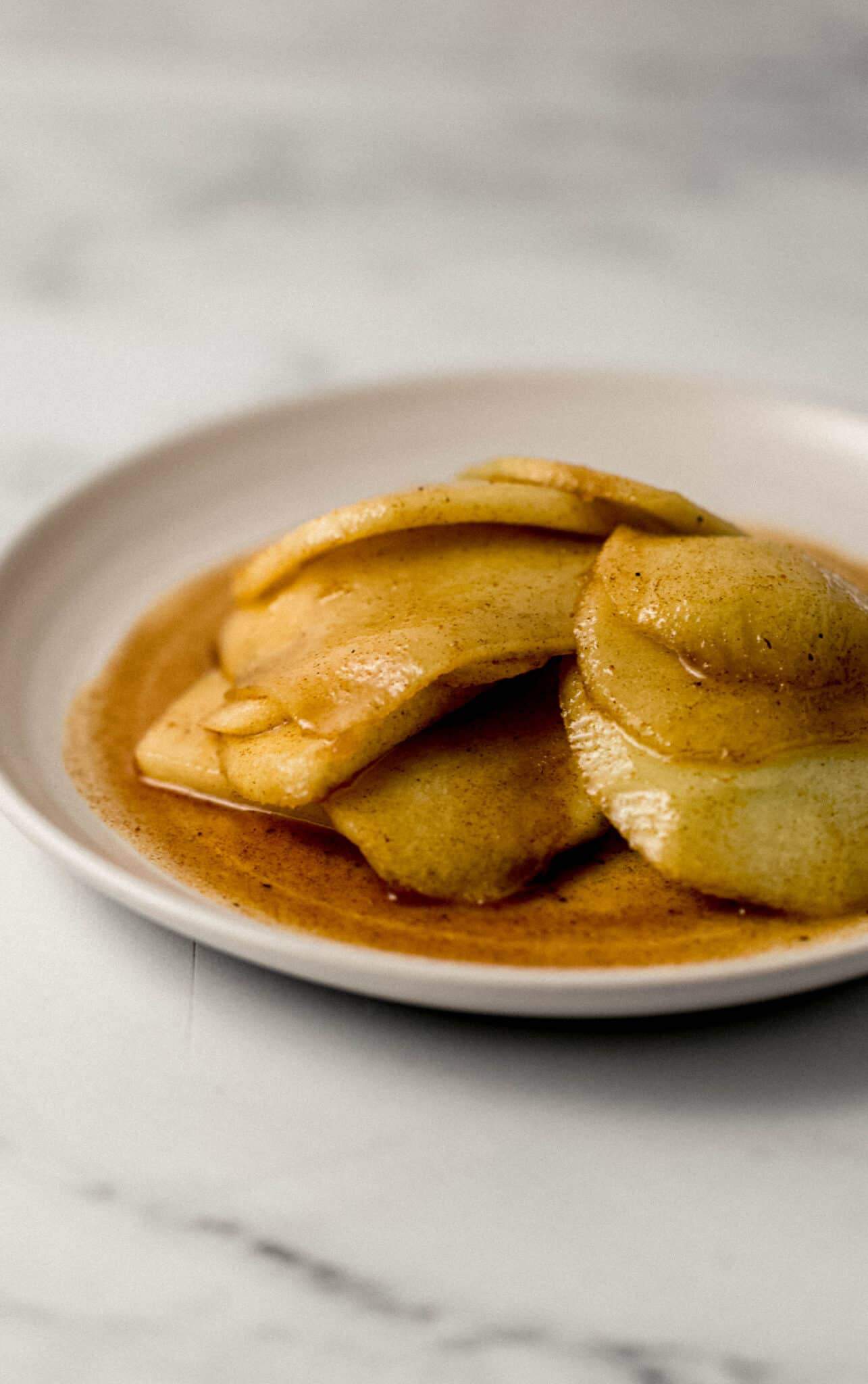 close up side view of a plate of fried apples 