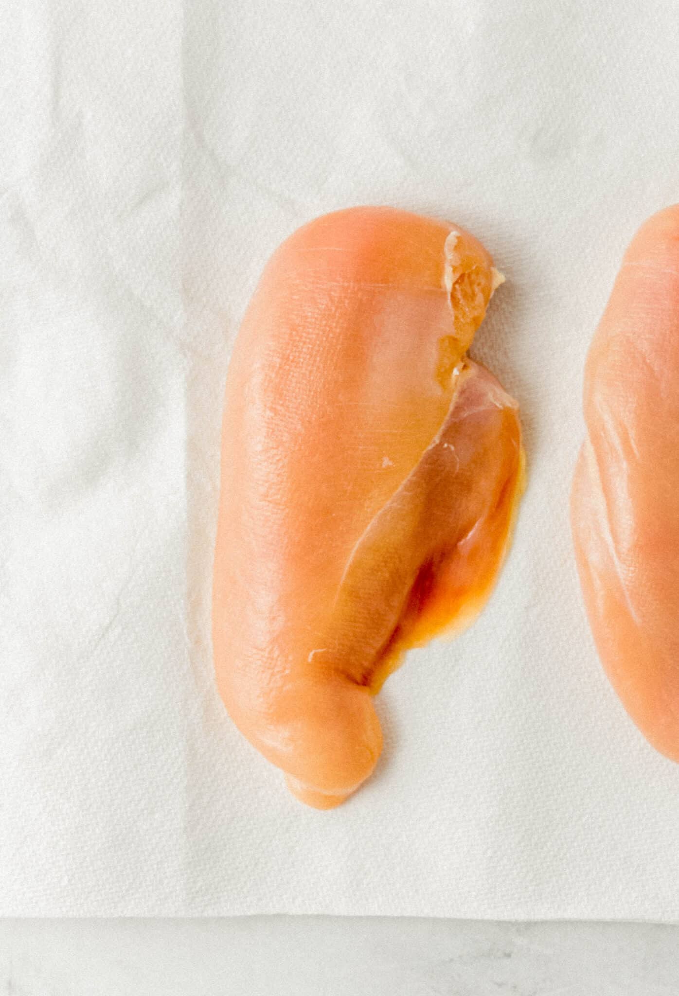 raw chicken breast on paper towels