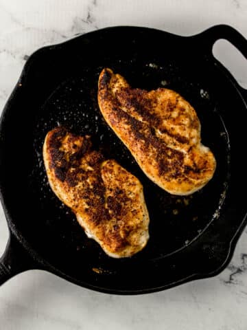 overhead view of chicken in cast iron skillet