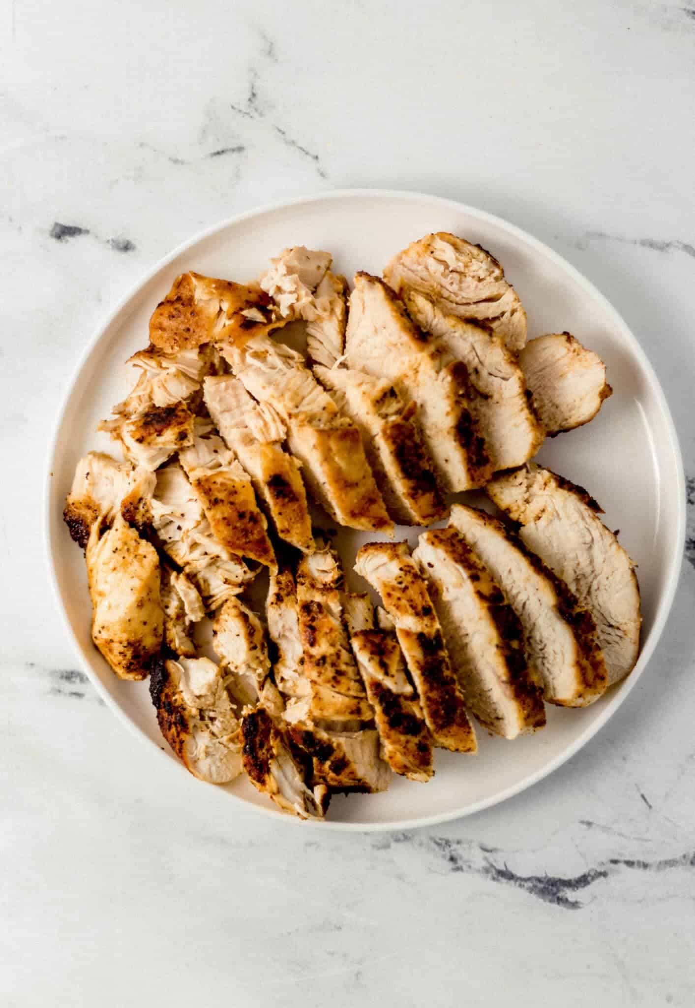 sliced chicken breast on white plate 