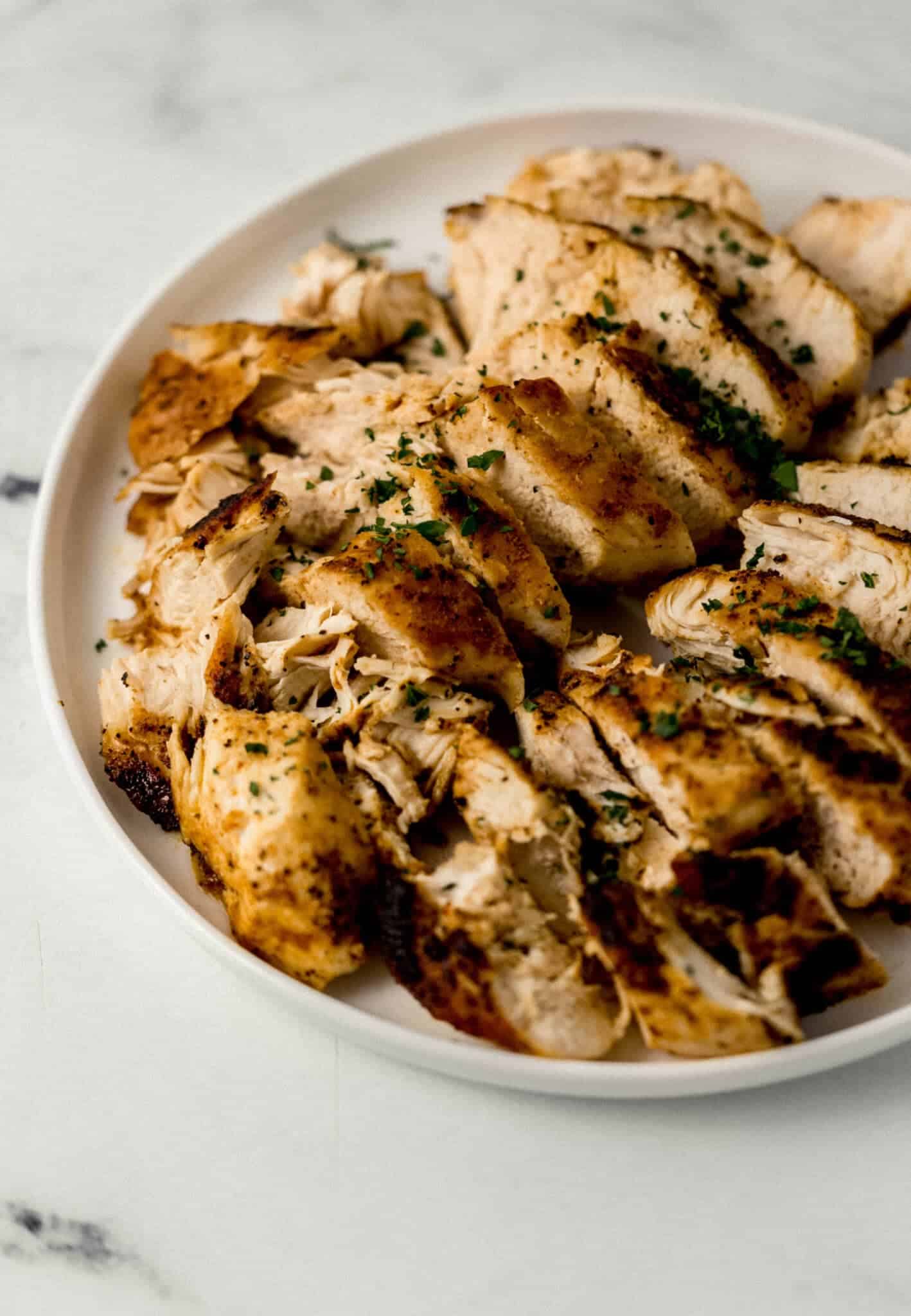 close up view of finished chicken on white plate 