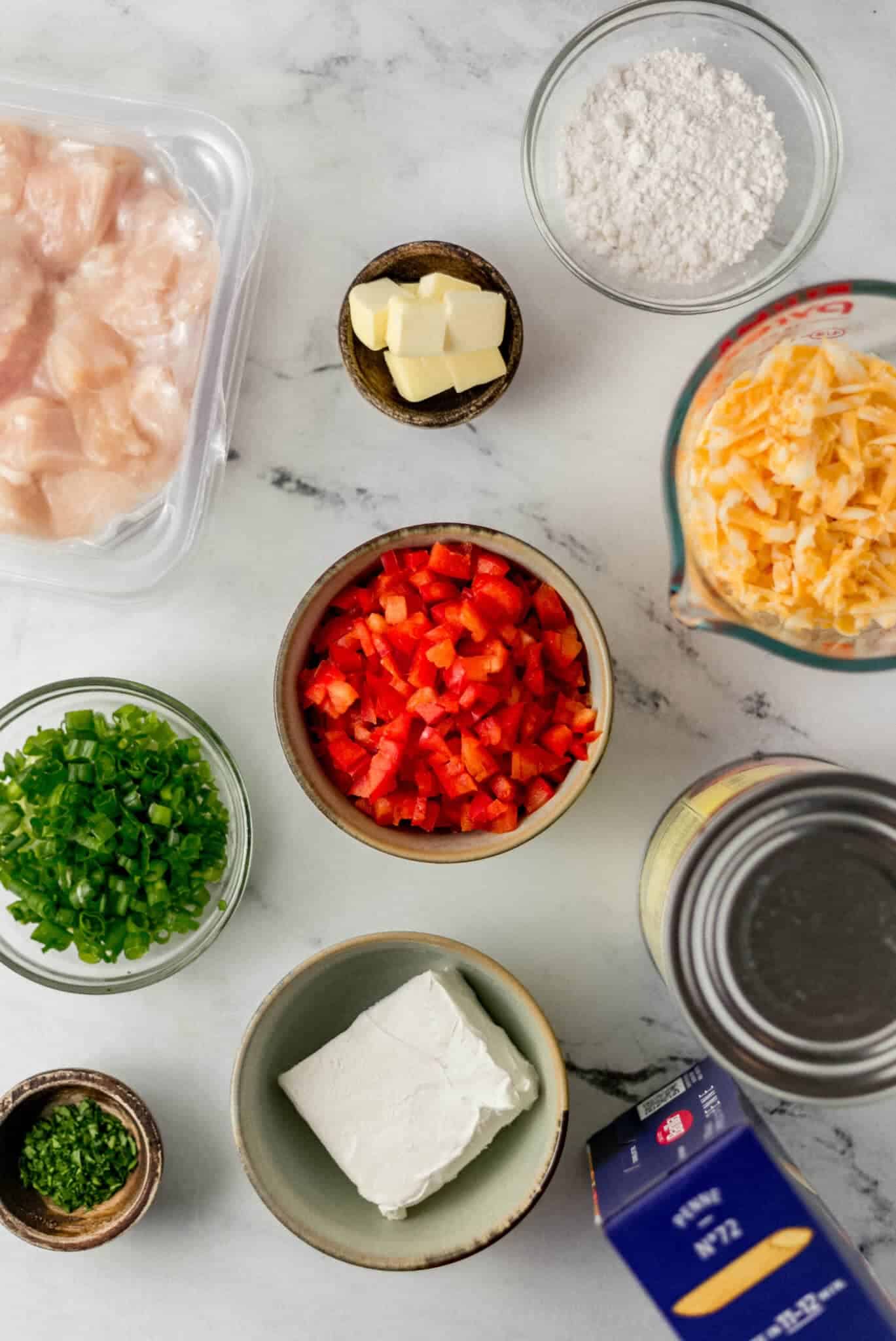 overhead view of ingredients needed to make pasta in separate bowls and containers 