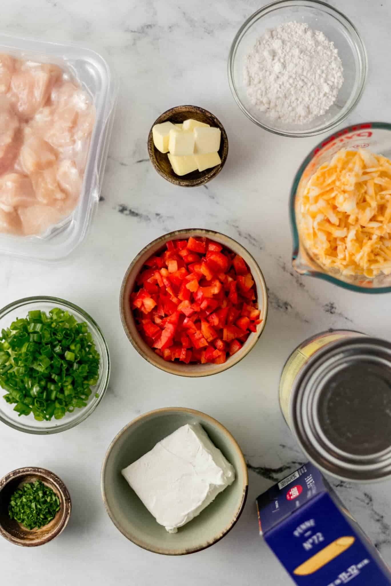 overhead view of ingredients needed to make pasta in separate bowls and containers