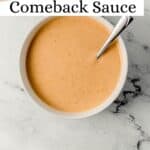 Overhead view of comeback sauce in white bowl with spoon in it on pin with text overlay.