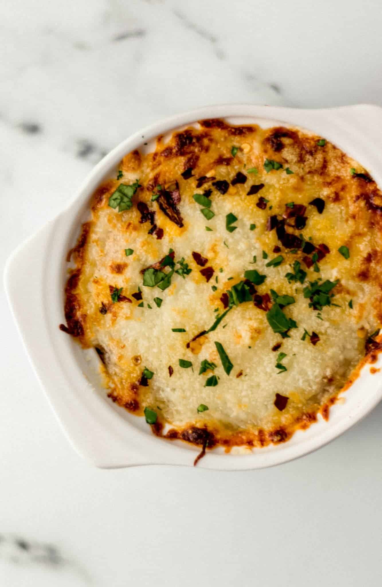 finished pizza bowl topped with chopped parsley 