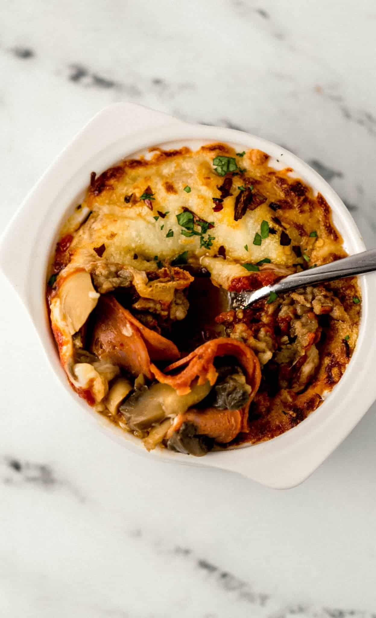 finished pizza bowl with spoon in it
