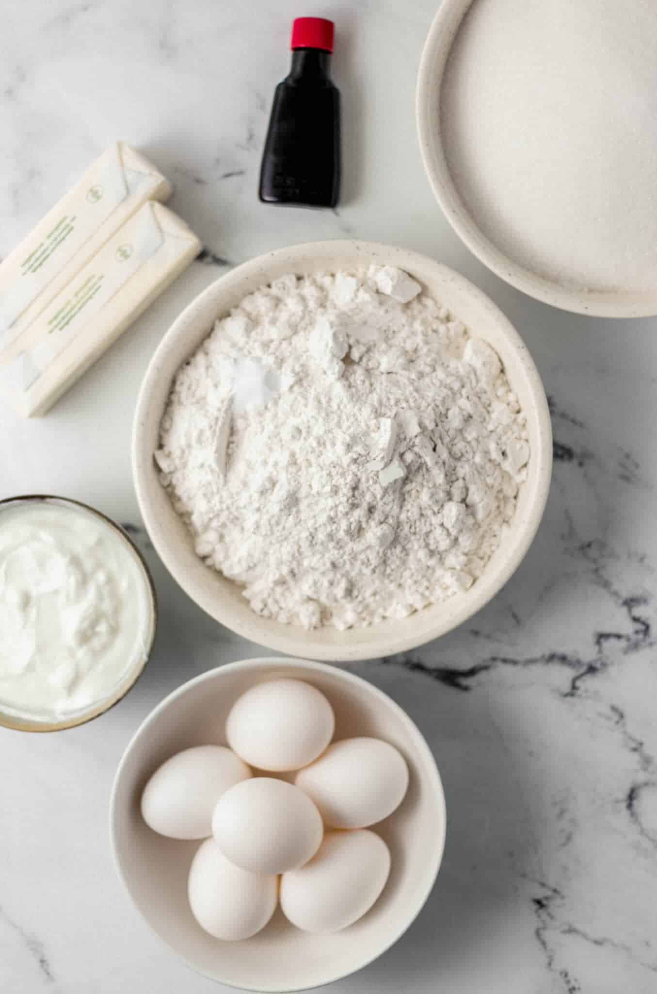 overhead view of ingredients needed to make pound cake in separate bowls