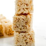 Close up side view of rice krispie treats stacked on top of each other.