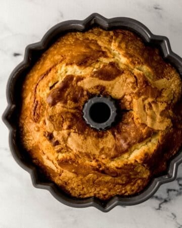 Overhead view of baked pound cake in bundt pan.