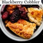 Close up view of serving of cobbler in white bowl pin with text overlay.
