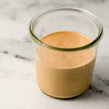 close up side view of comeback sauce in a jar