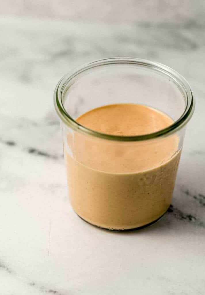 close up side view of comeback sauce in a jar