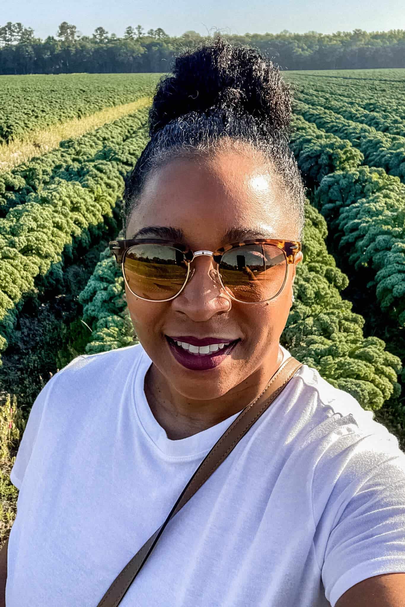 close up photo of lakita in field of rows of kale 