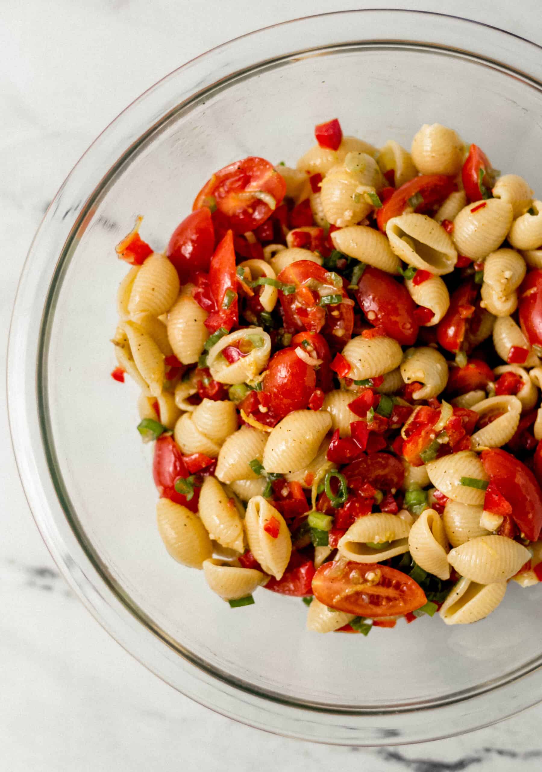 finished pasta salad in large glass mixing bowl 