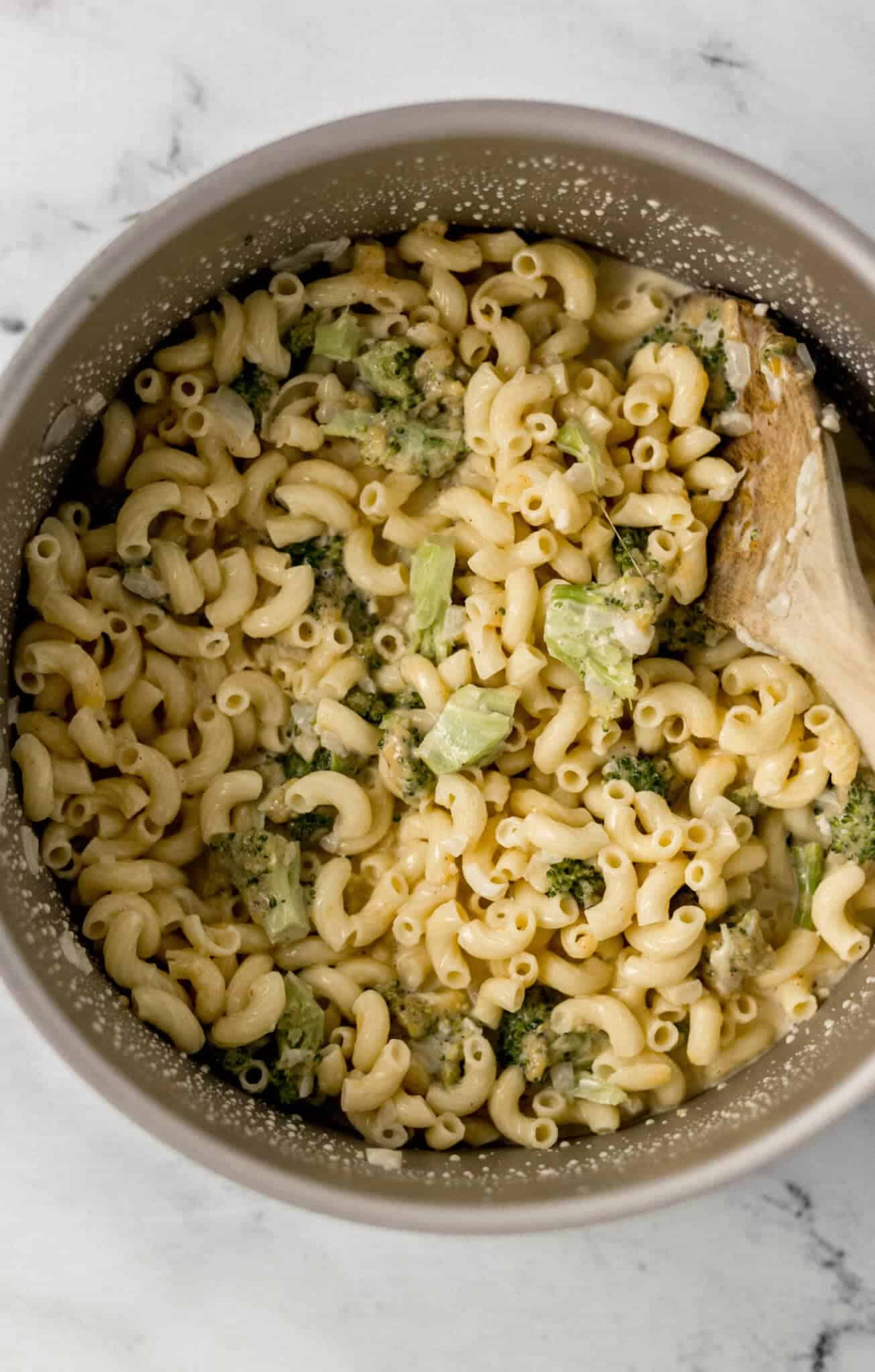 finished pasta in large pot with wooden spoon in it