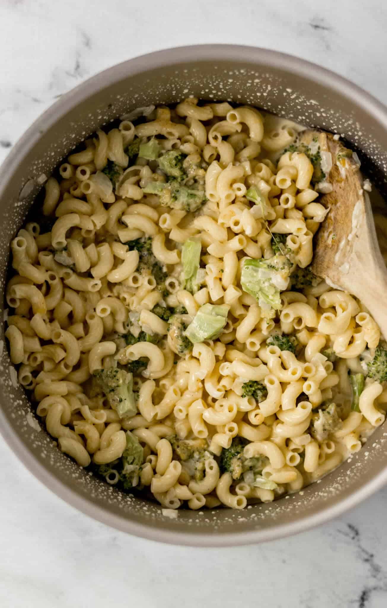 finished pasta in large pot with wooden spoon in it 