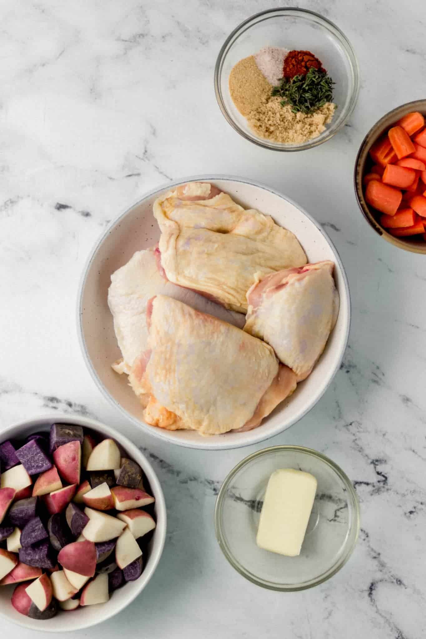 overhead view of ingredients needed to make chicken recipe in separate bowls