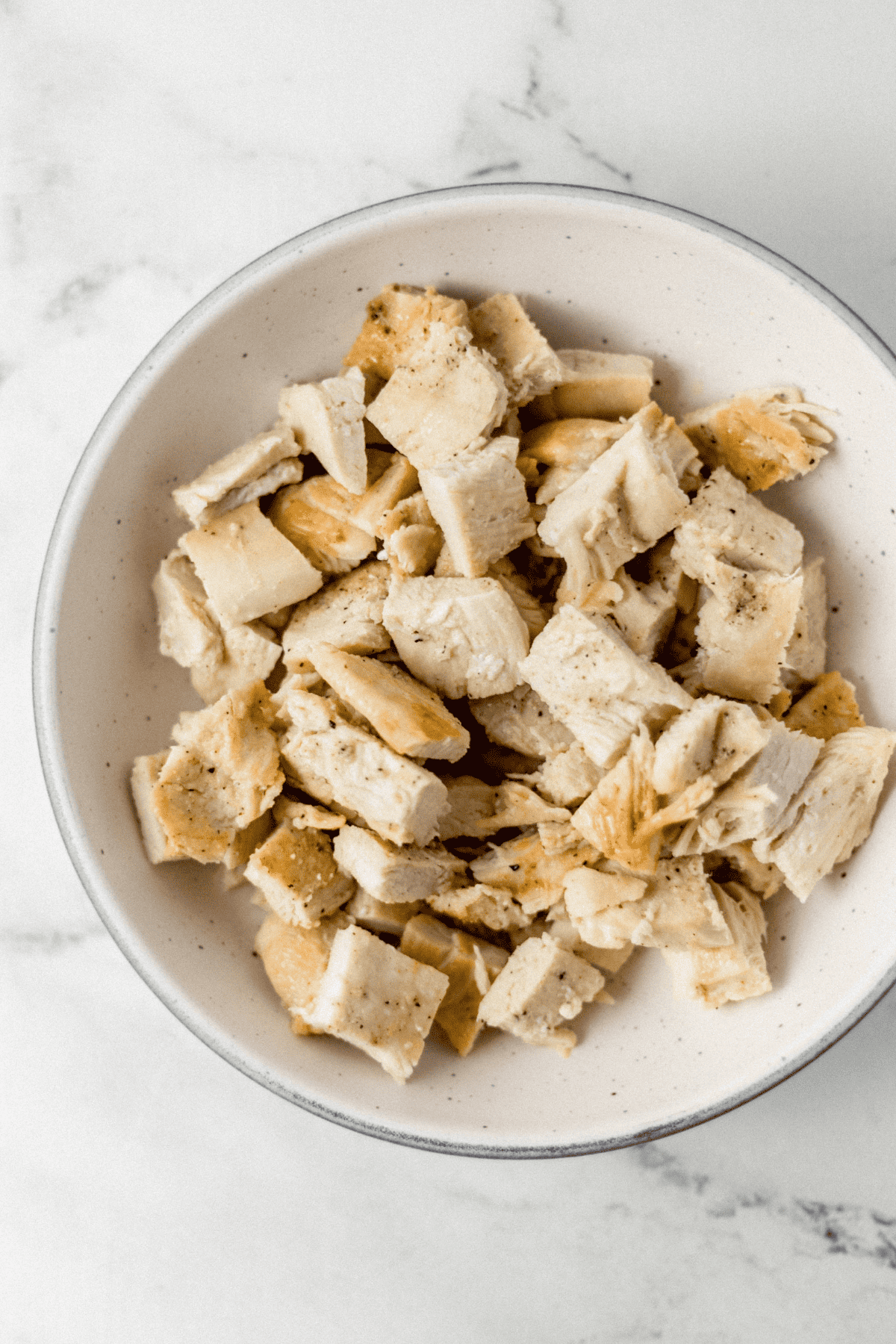 overhead view of cooked chicken in bowl
