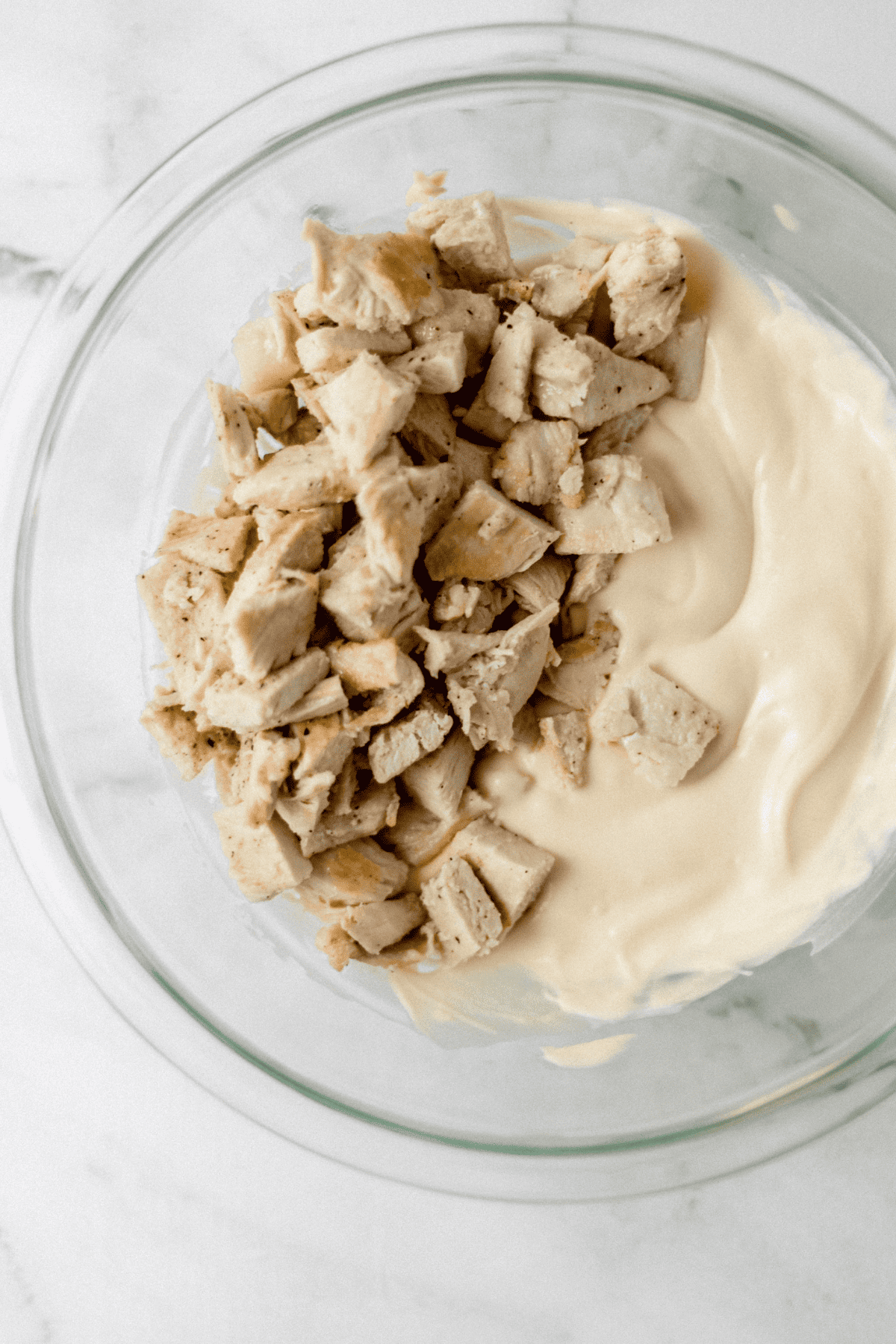 Mix together the soup and mayo for the chicken and broccoli casserole chicken and mayo mixture in glass mixing bowl
