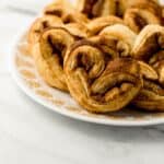 close up side view of finished elephant ears on large white plate