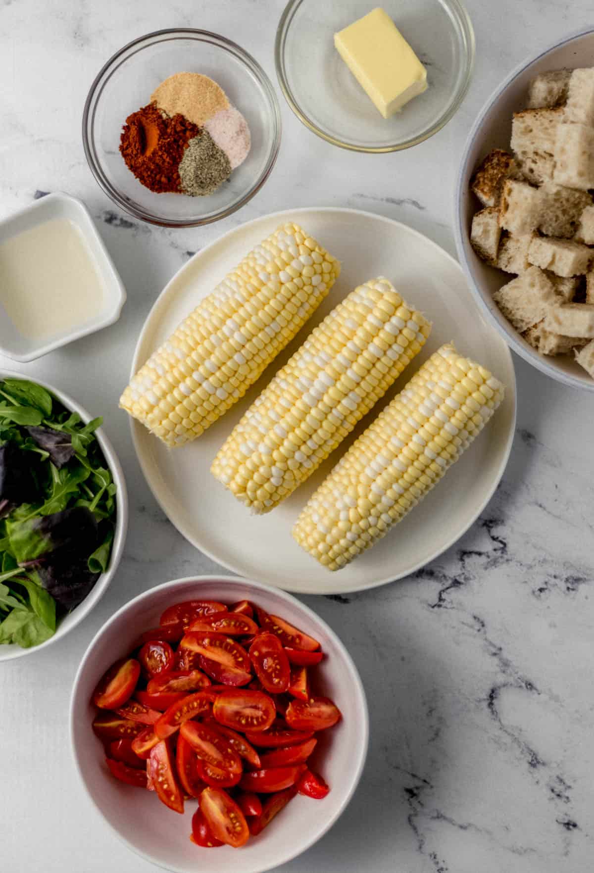 overhead view of ingredients needed to make salad in separate bowls