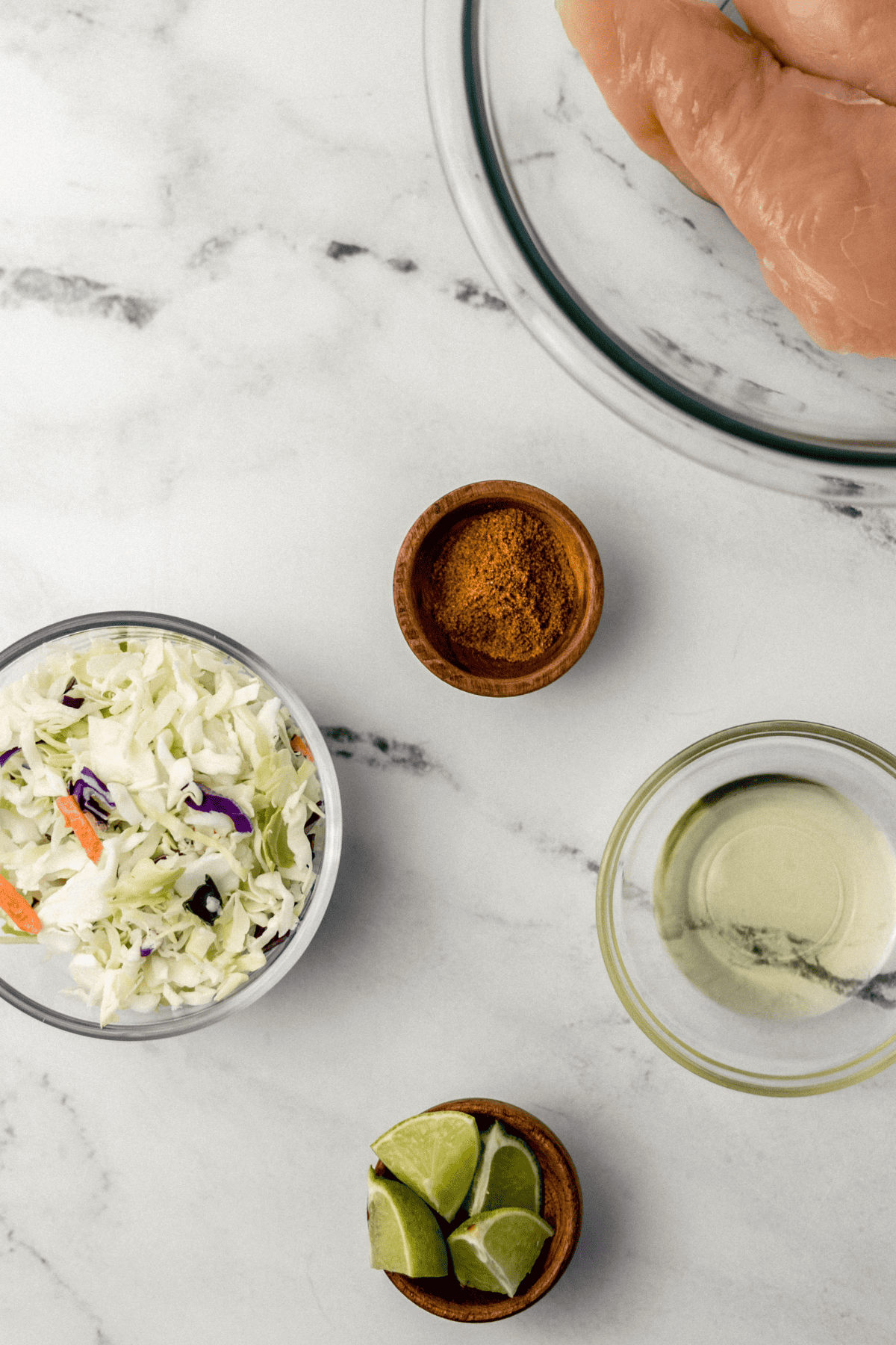 overhead view of ingredients needed to make jerk tacos in separate bowls