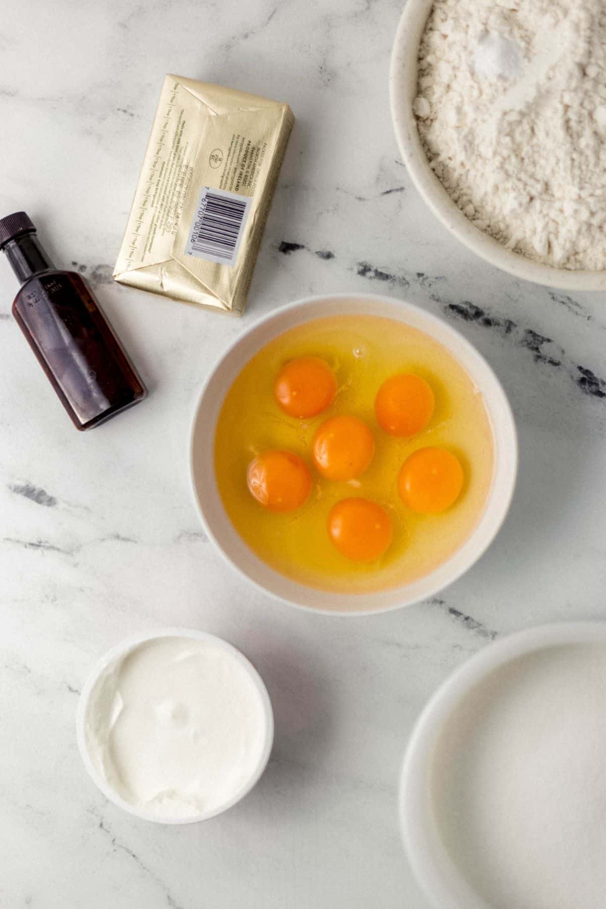 overhead view of ingredients needed to make pound cake in separate bowls and containers 