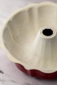 Prepared bundt pan on marble surface.