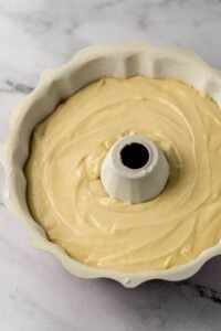 Cake batter added to the prepared bundt pan.