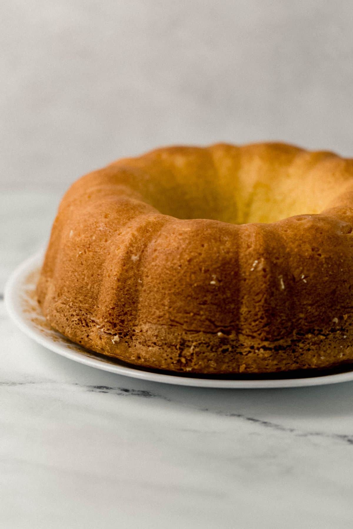 close up side view of finished pound cake on plate 