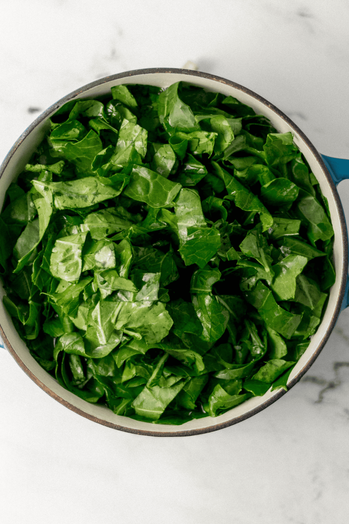 prepared greens added to large pot with the other ingredients 