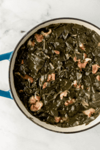 cooked greens in large pot on marble surface