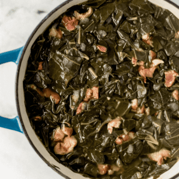 cooked greens in large pot on marble surface