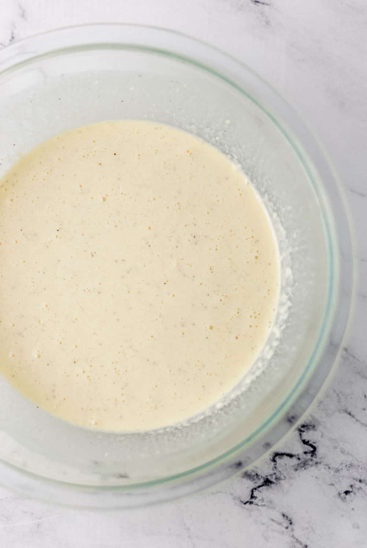 egg mixture for quiche in large glass mixing bowl 