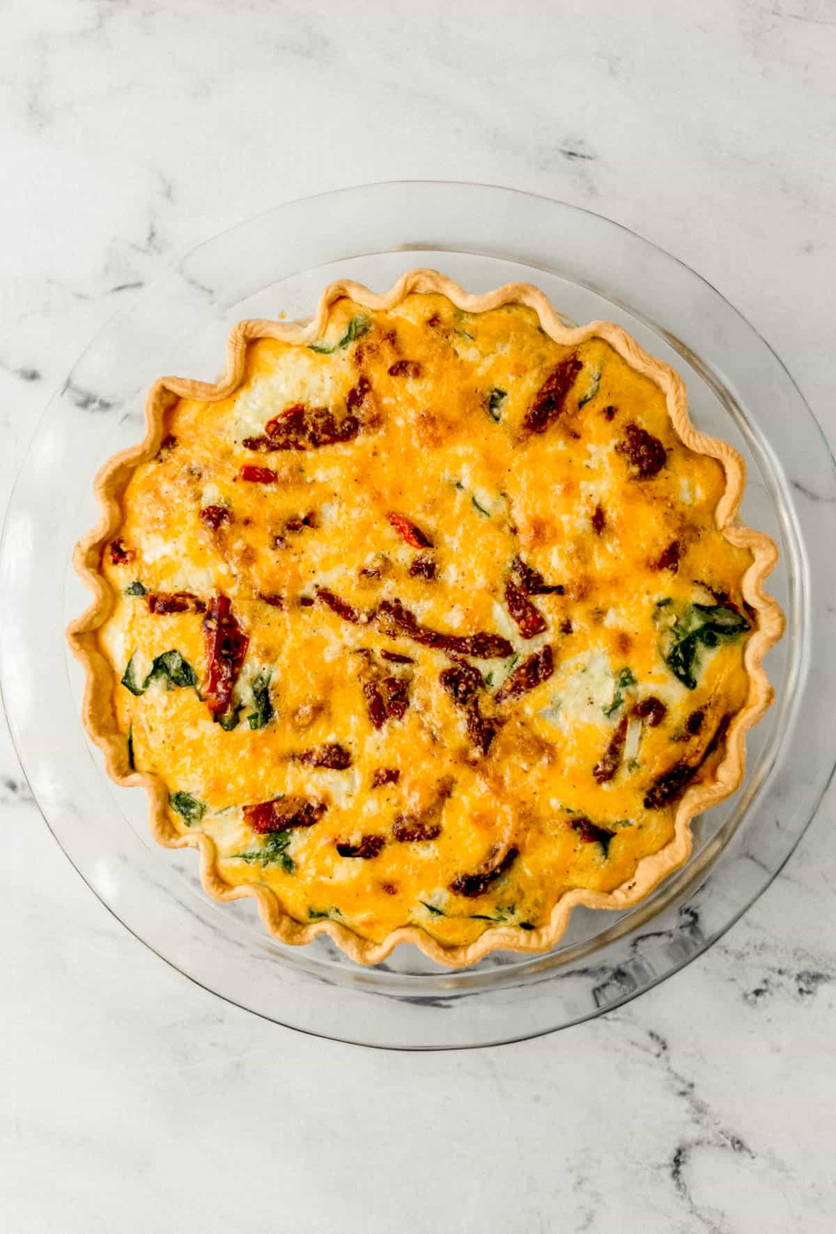 overhead view of finished quiche in glass pie pan