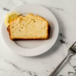 slice of bread on white plate beside fork