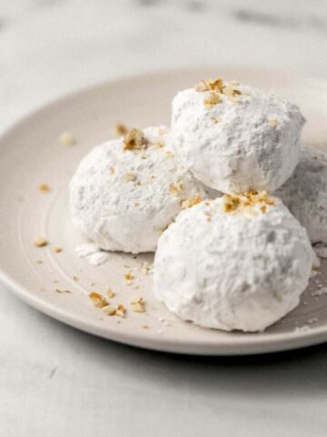close up side view of cookies stacked on plate