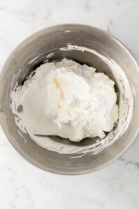 Overhead view of whipped heavy cream in bowl.
