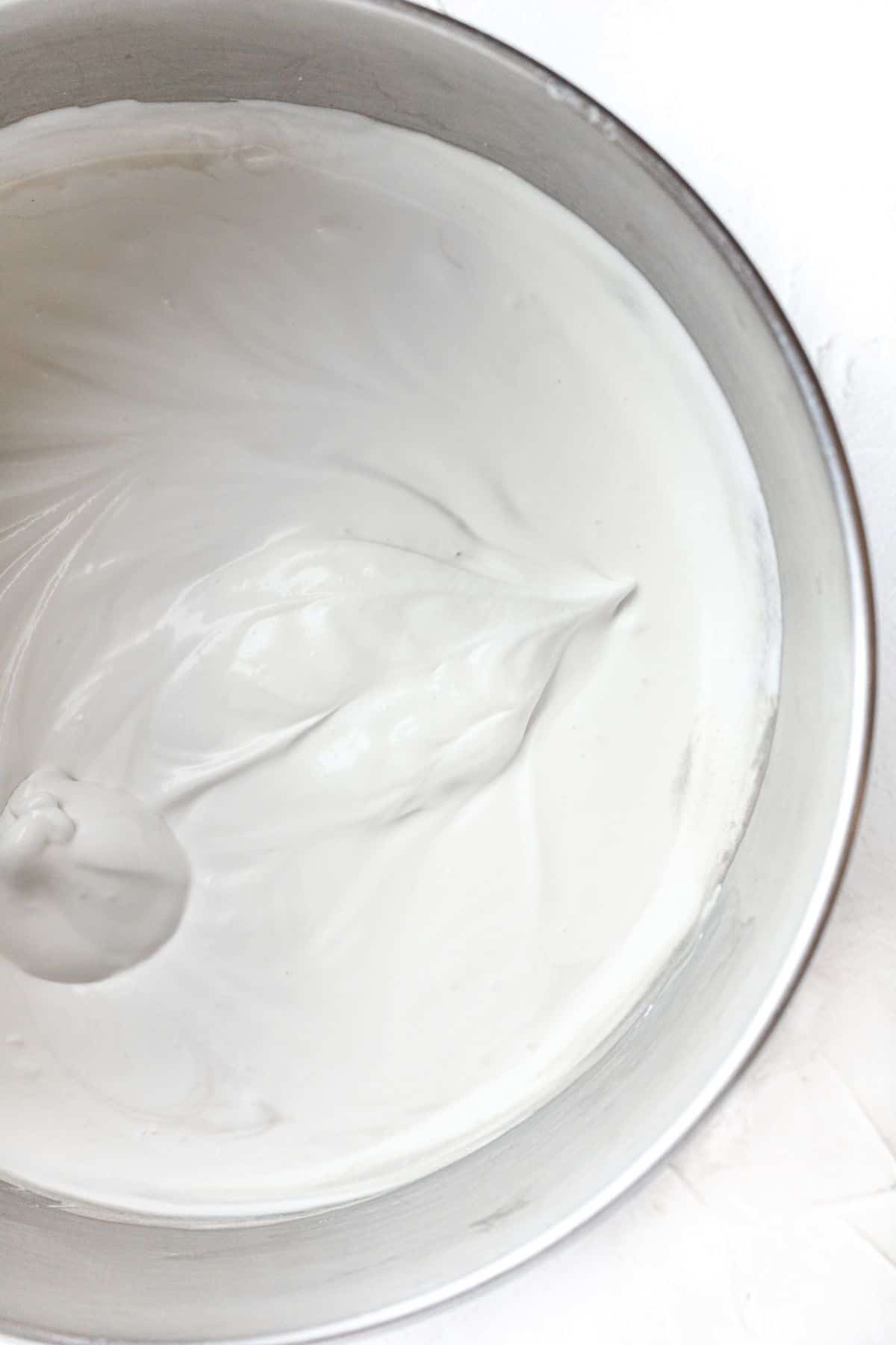 condensed milk added to stand mixer bowl with heavy cream 