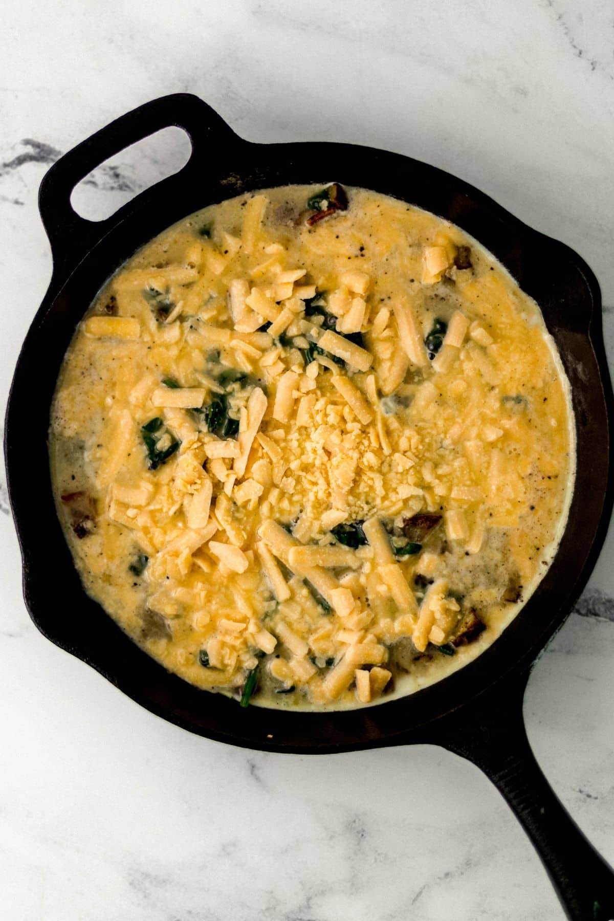 all of the fritatta ingredients combined and added to a cast iron skillet 
