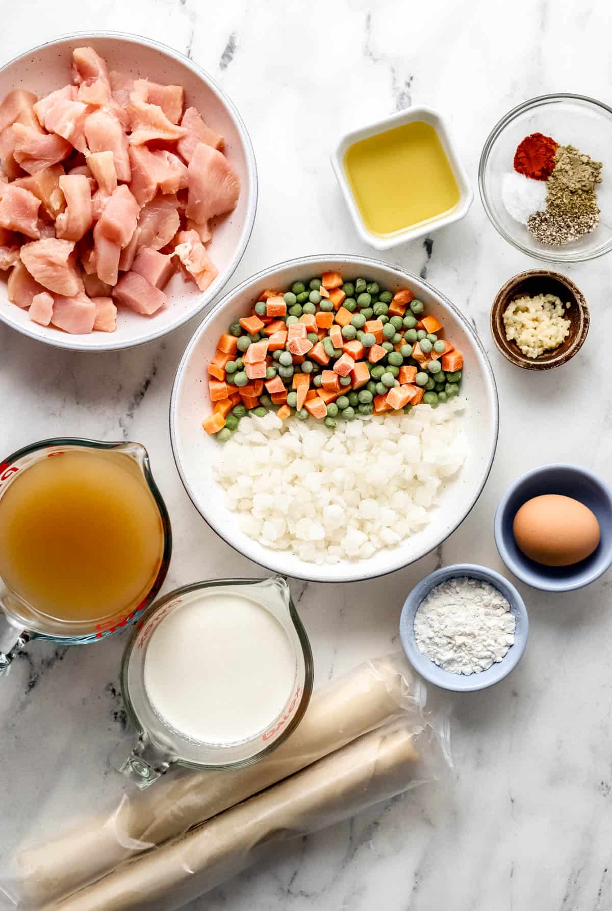 overhead view of ingredients needed to make pot pie in separate bowls and containers 