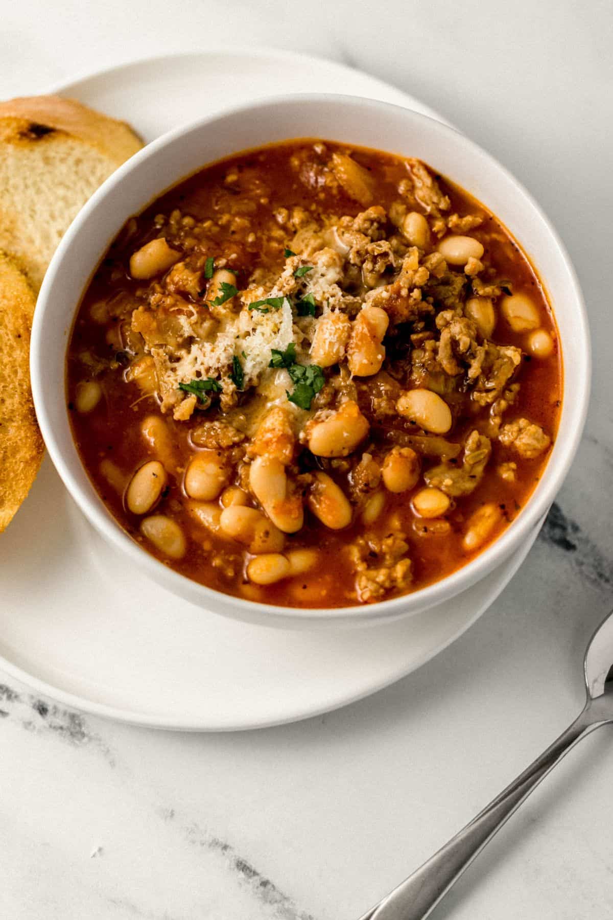 close up view of bowl of soup on a white plate 