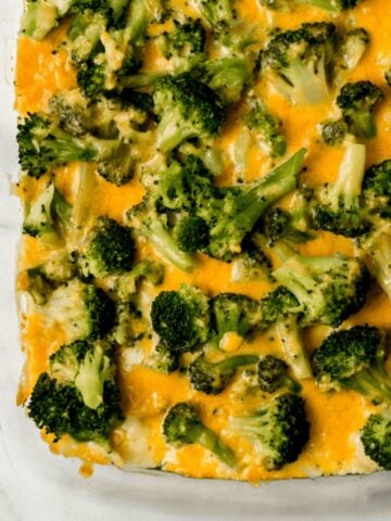 finished broccoli casserole in glass baking dish on marble surface