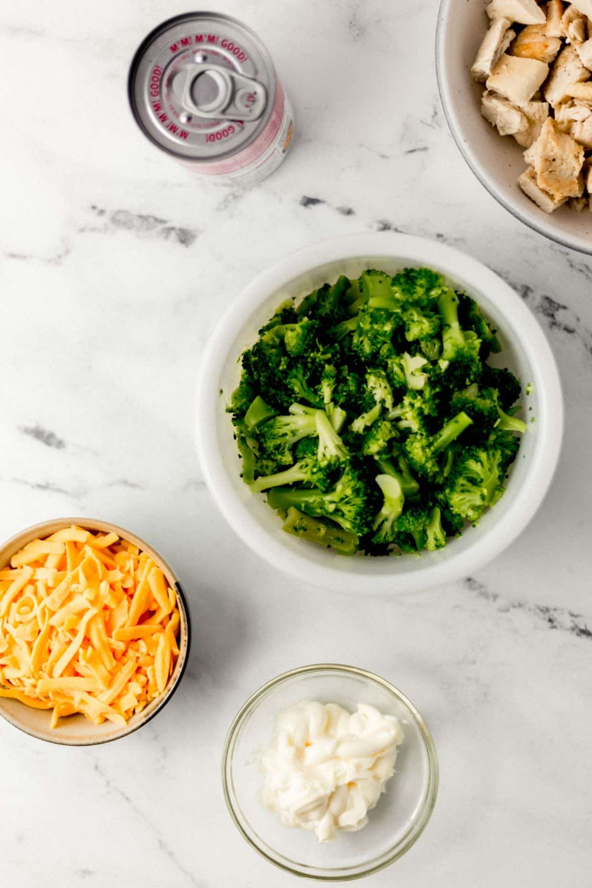 overhead view of ingredients needed to make casserole in separate bowls on marble surface 