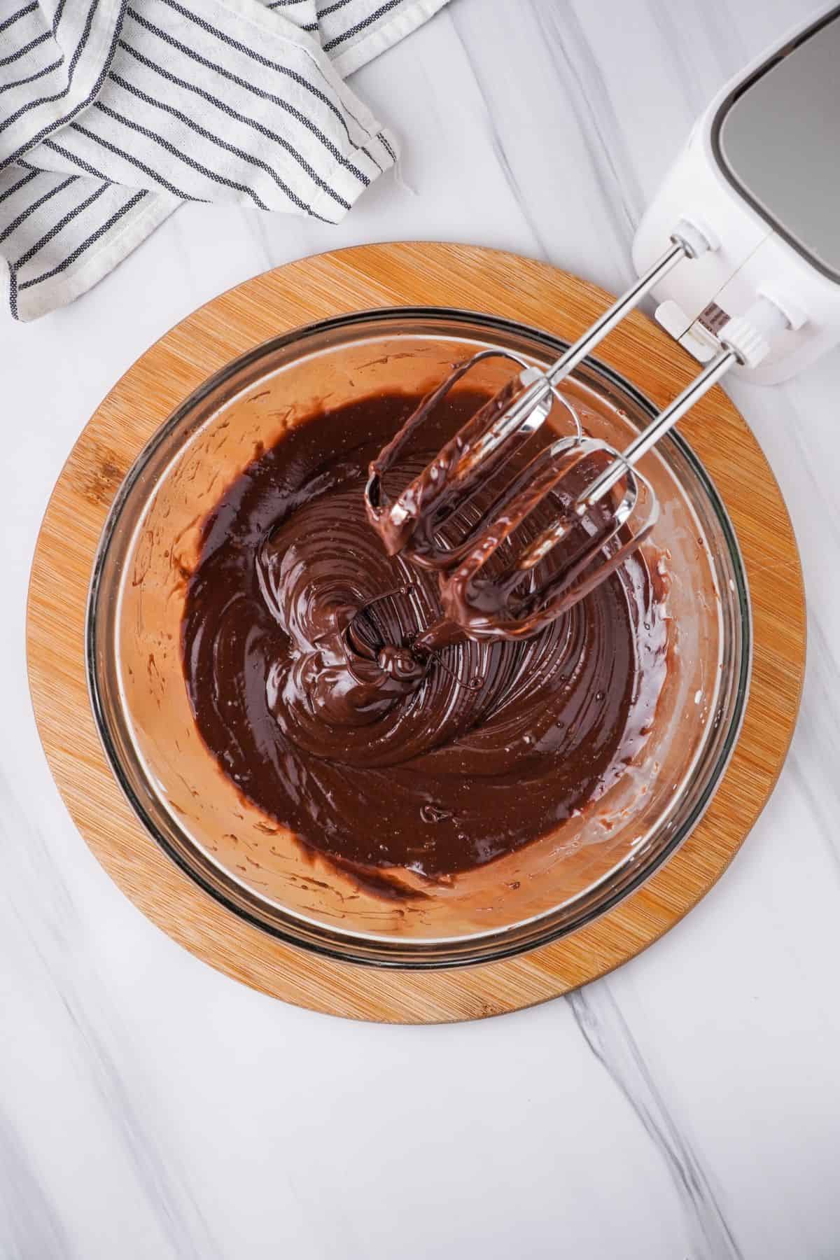 Instant chocolate pudding and milk added to glass bowl and mixed with hand mixer. 