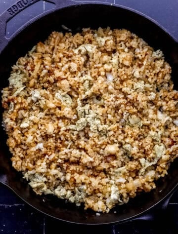 Rice added to the cast iron skillet with onion and butter.