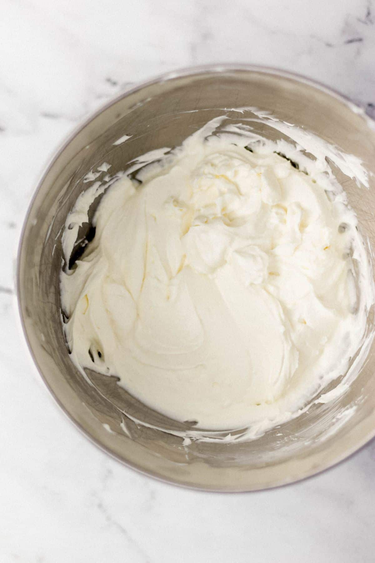 overhead view of cream for trifle in stand mixer bowl 